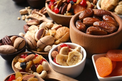 Composition of different dried fruits and nuts on table, closeup