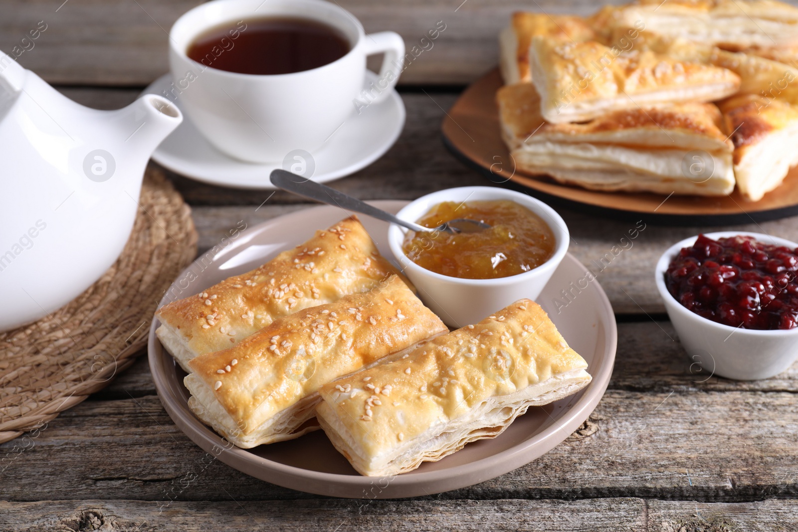 Photo of Delicious puff pastry served on wooden table