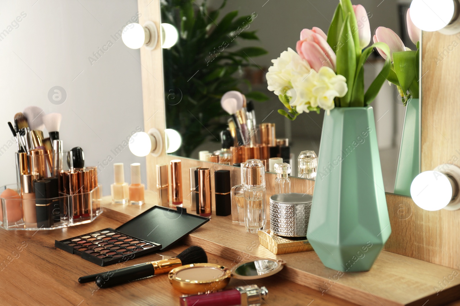 Photo of Dressing table with set of luxury cosmetic products. Interior element