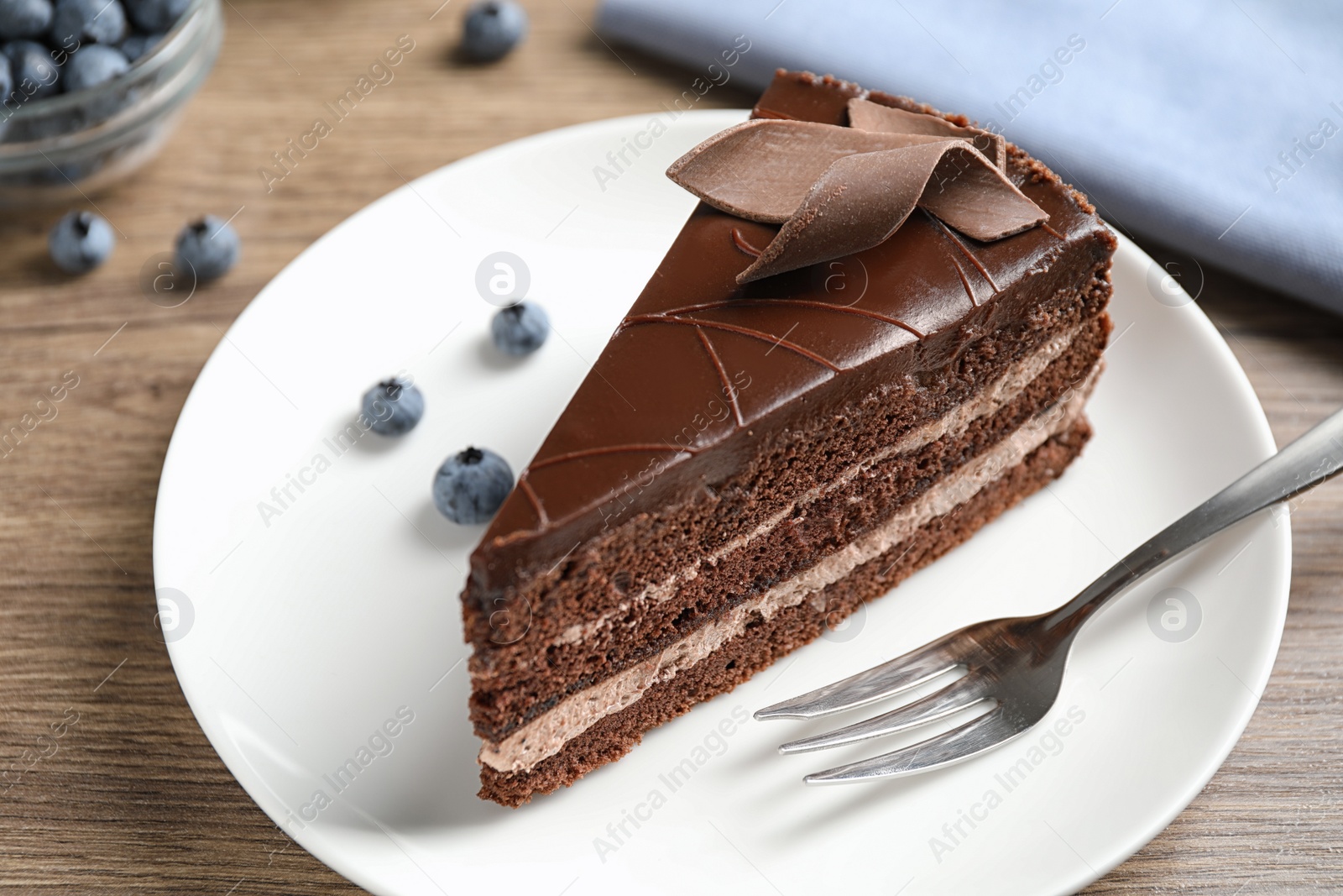 Photo of Delicious fresh chocolate cake served on wooden table