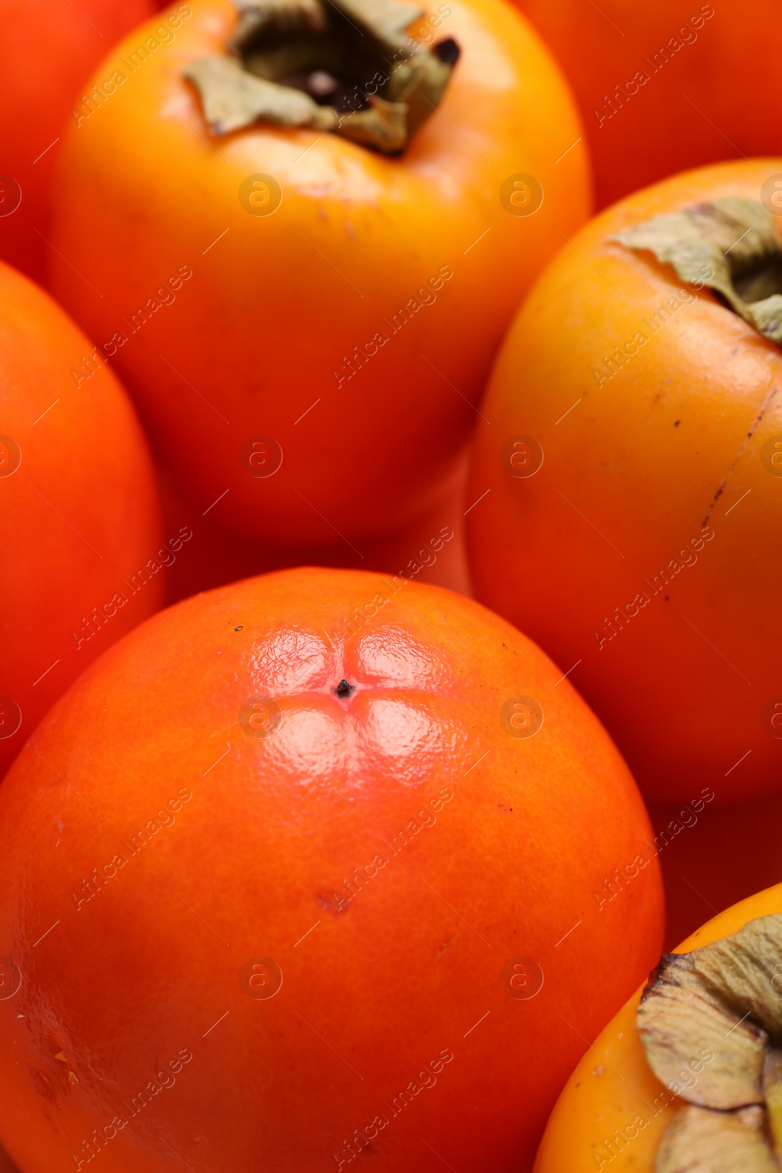 Photo of Delicious ripe juicy persimmons as background, closeup