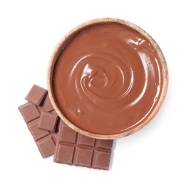 Photo of Tasty milk chocolate paste in bowl and pieces isolated on white, top view