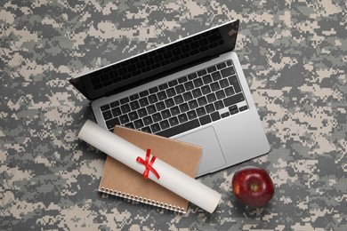 Notebook, diploma, laptop and apple on camouflage background, flat lay. Military education