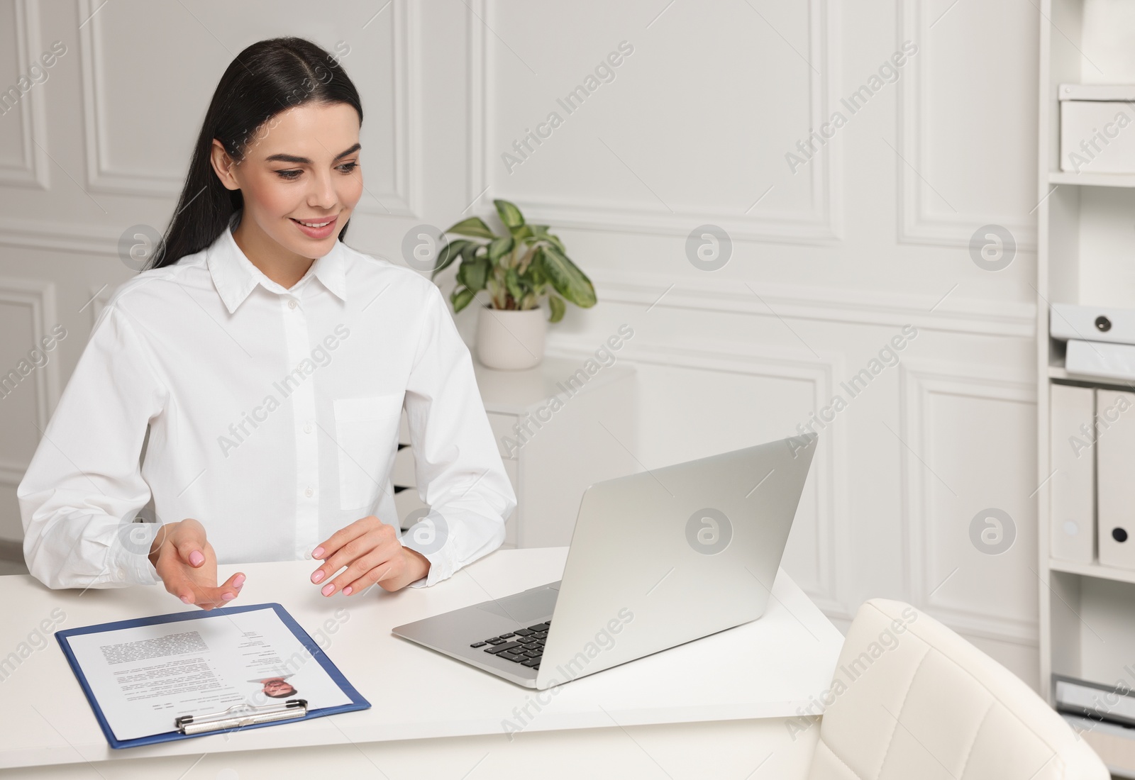 Photo of Human resources manager conducting online job interview via video chat on laptop