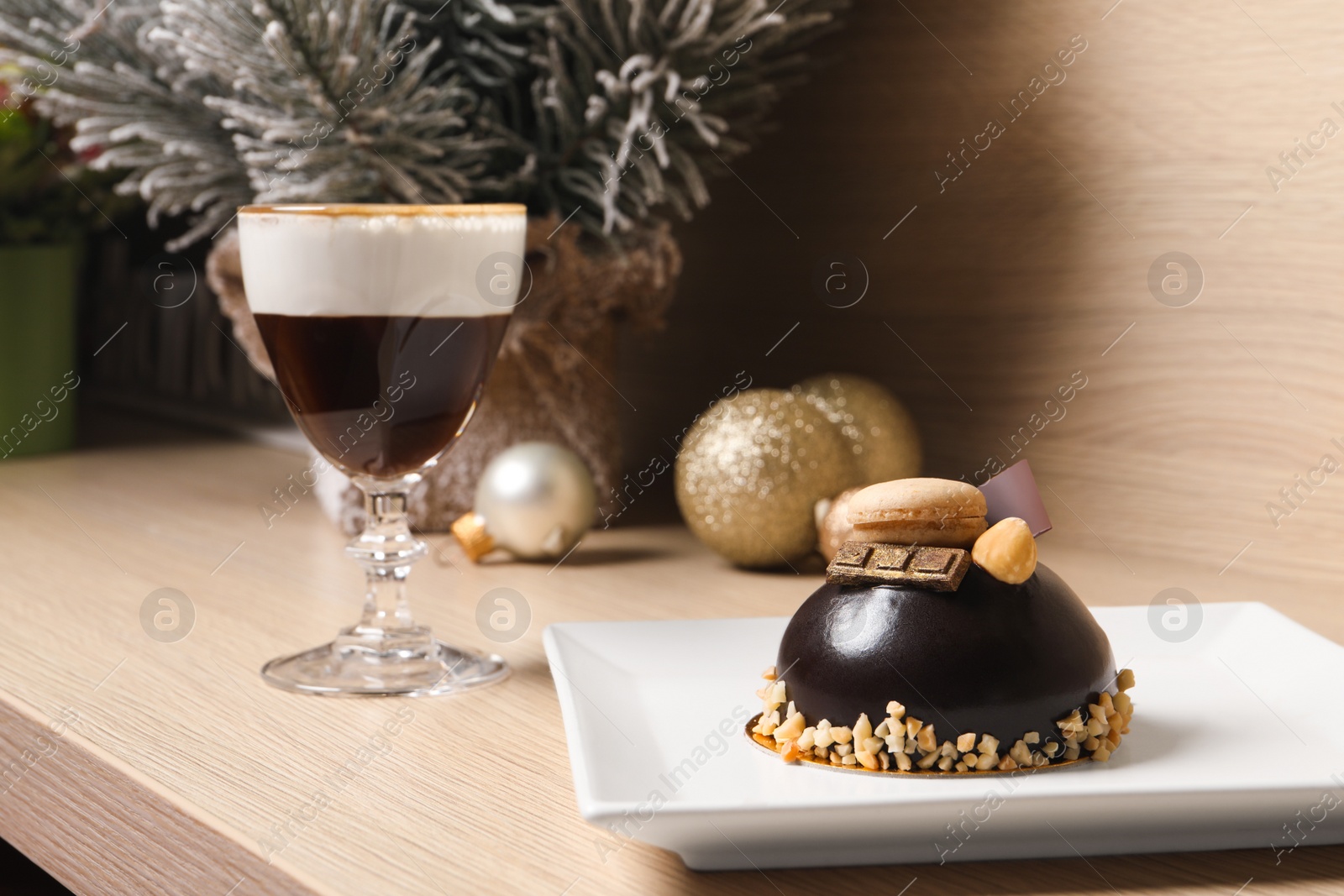 Photo of Delicious chocolate dessert and aromatic coffee drink on wooden table