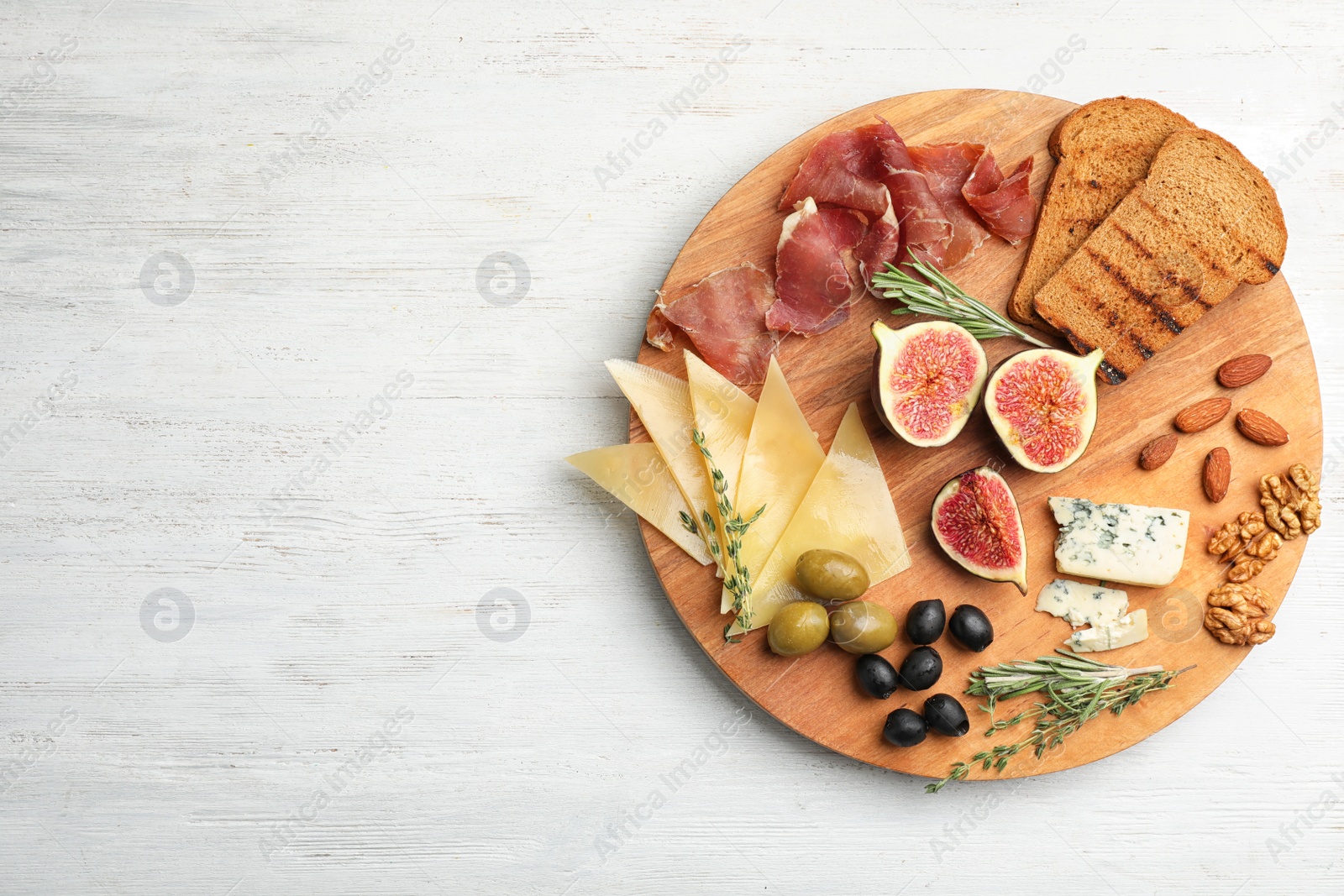 Photo of Flat lay composition with ripe figs and delicious products on wooden background. Space for text