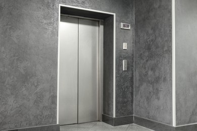 Photo of Closed silver stylish elevator door in hall