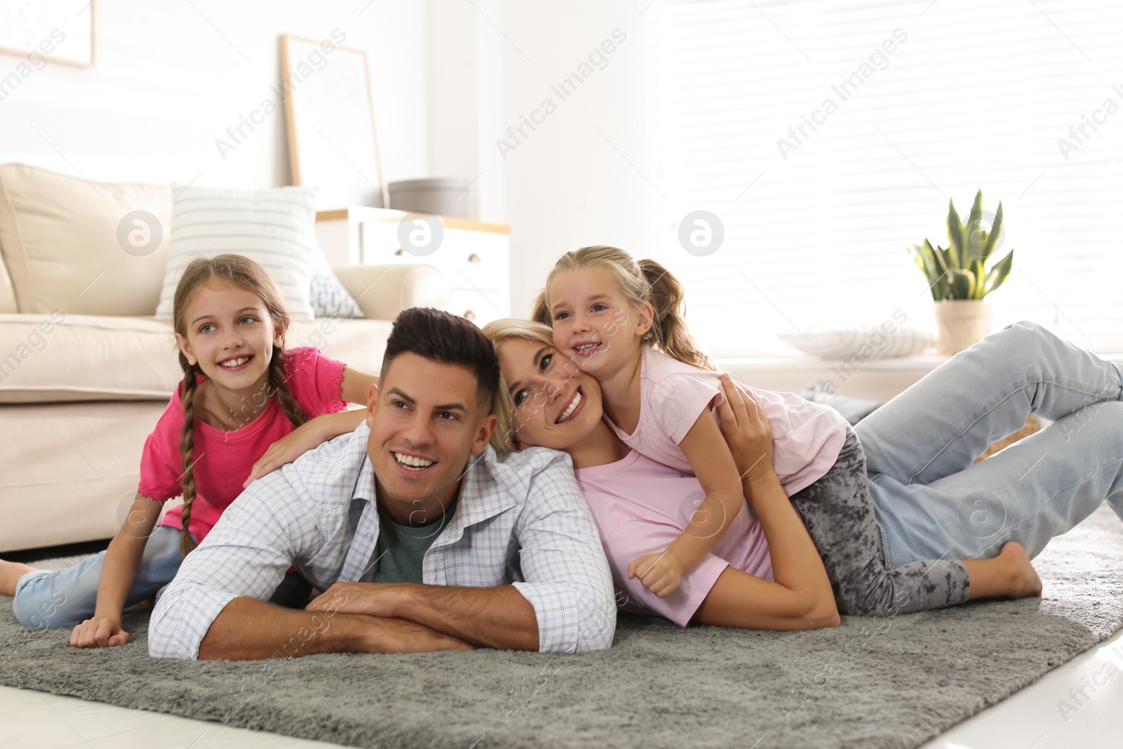 Photo of Happy family with children on floor at home