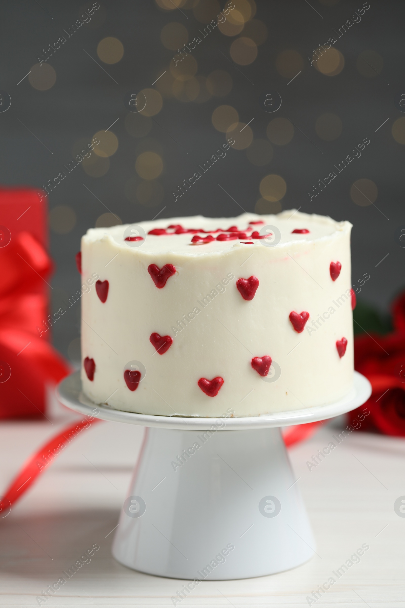 Photo of Bento cake on white wooden table, closeup. St. Valentine's day surprise