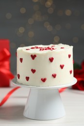 Photo of Bento cake on white wooden table, closeup. St. Valentine's day surprise