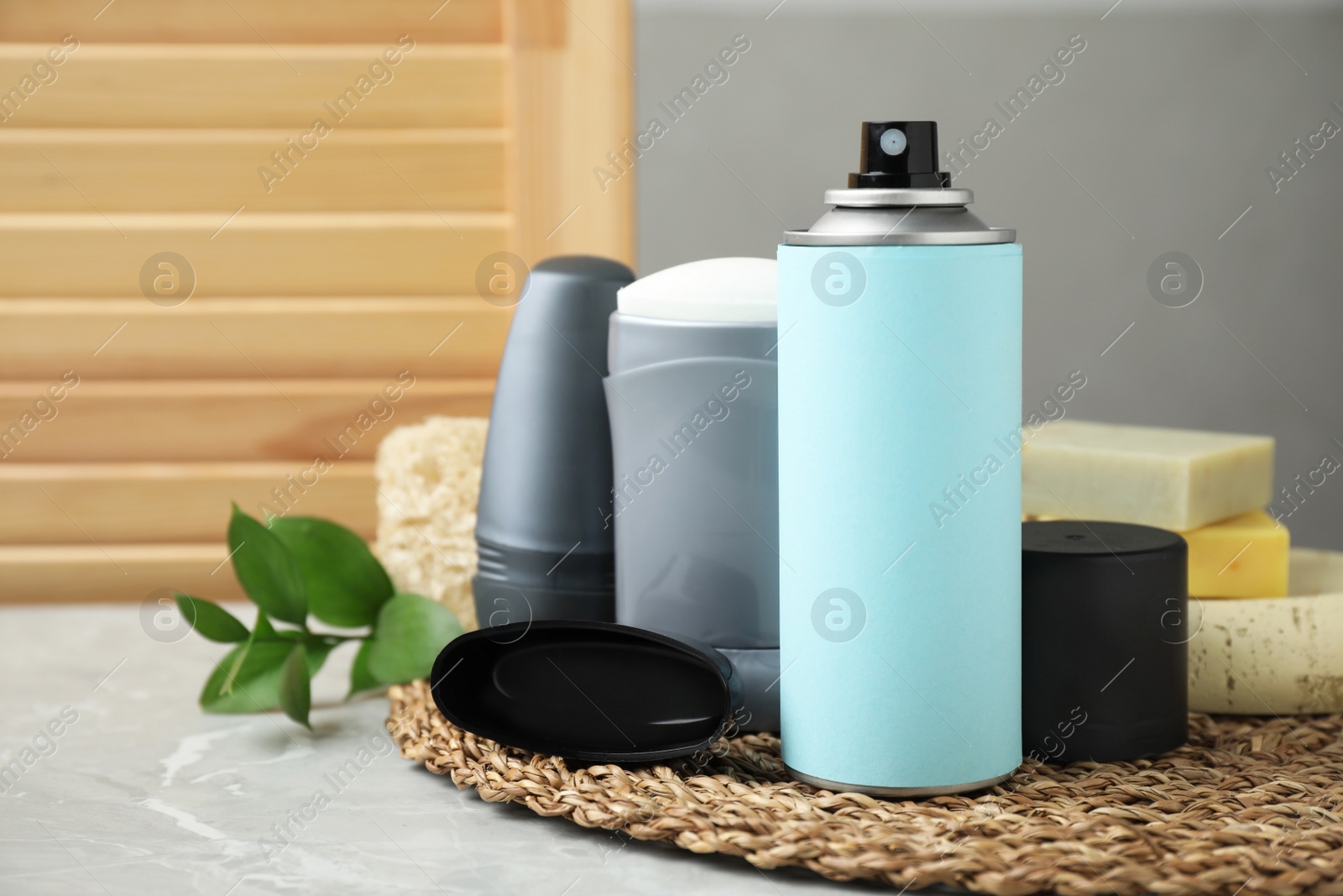 Photo of Composition with natural deodorants on light grey marble table