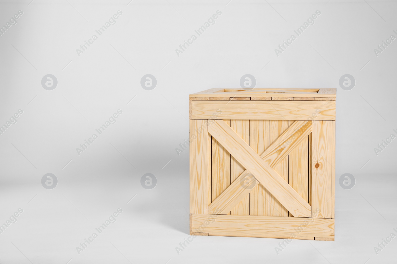 Photo of Closed wooden crate on grey background. Space for text