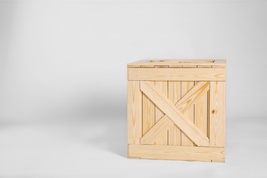 Photo of Closed wooden crate on grey background. Space for text