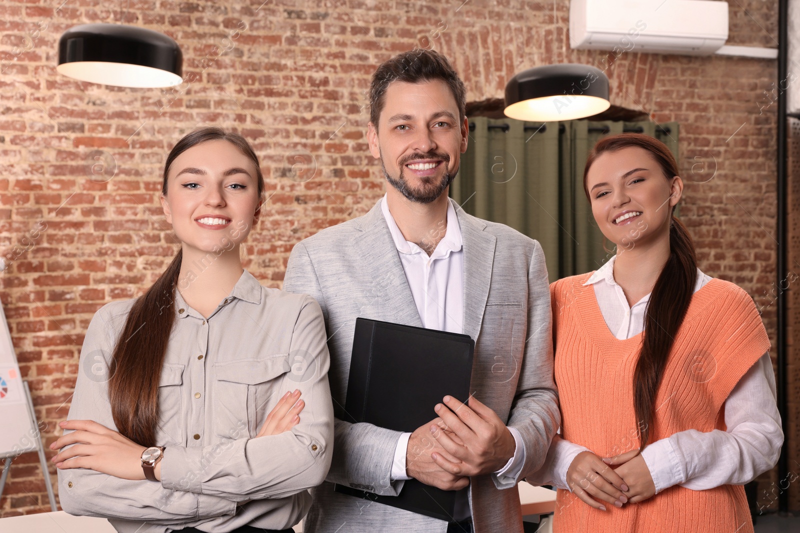 Photo of Portrait of happy employees in office. Team work