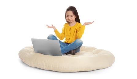 Photo of Little girl using video chat on laptop, white background