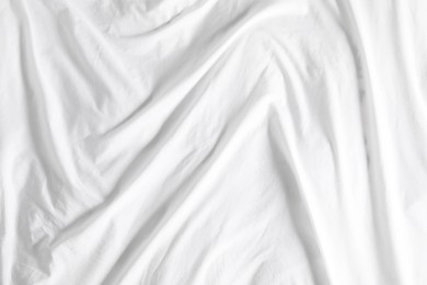 Photo of Crumpled white fabric as background, top view