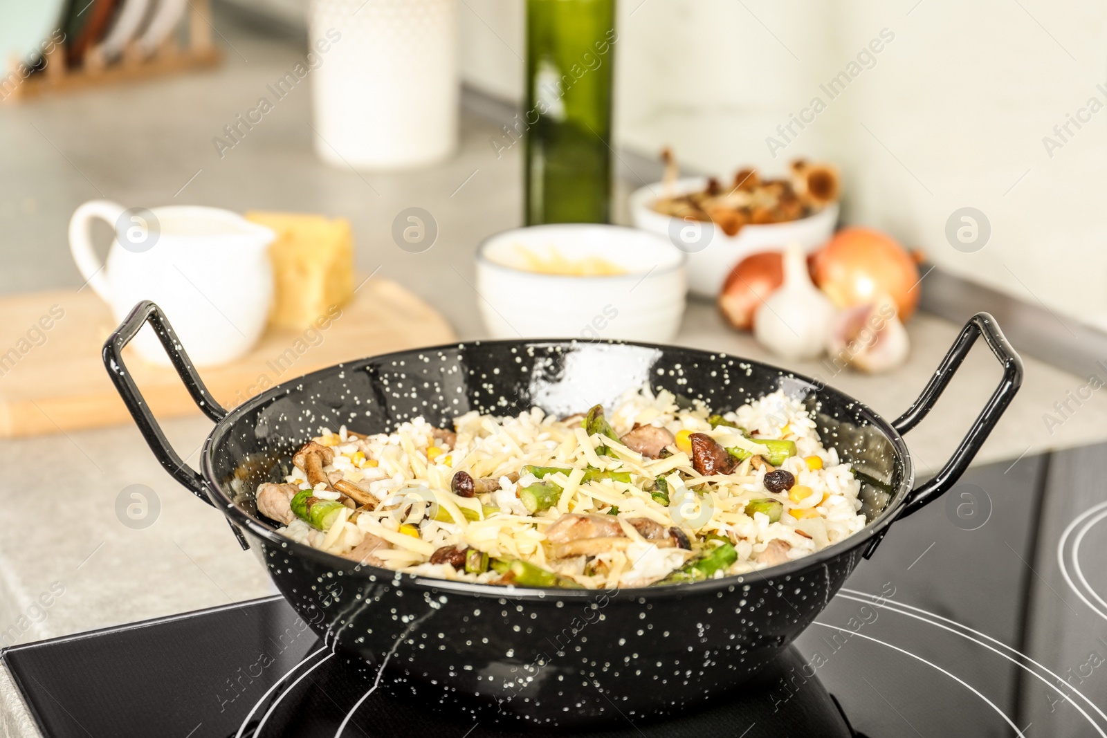 Photo of Delicious risotto in pan on induction stove