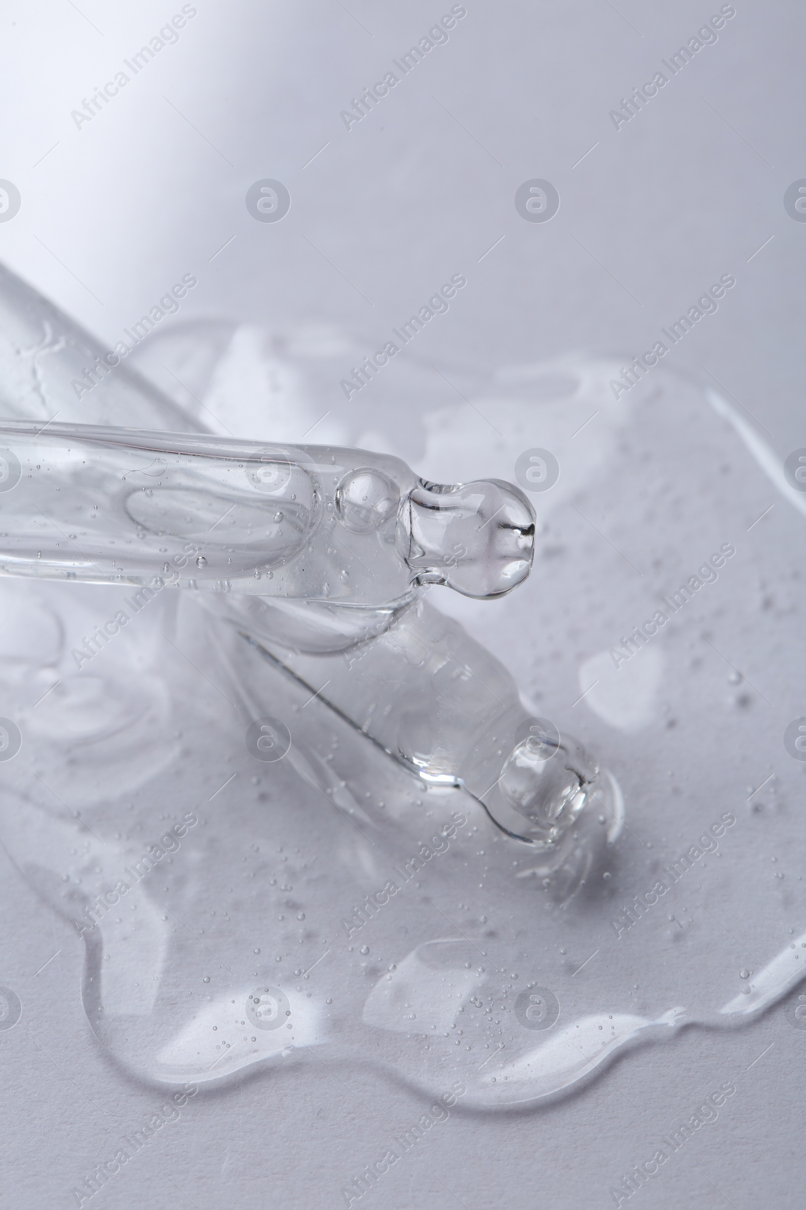 Photo of Pipettes with cosmetic serum on white background, closeup