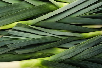 Photo of Fresh raw leeks as background, top view