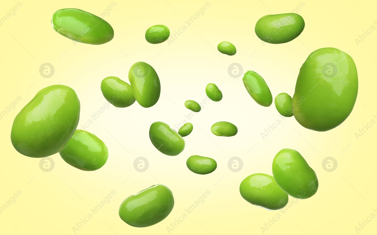 Image of Delicious edamame soybeans falling on light yellow background