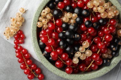 Photo of Different fresh ripe currants on light grey table, flat lay