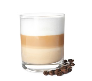 Delicious latte macchiato and coffee beans on white background