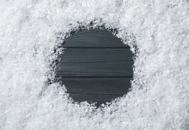 Photo of Frame made of snow on grey wooden background, top view with space for text. Christmas time
