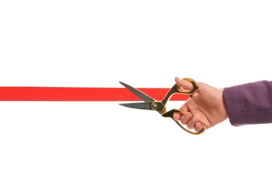 Photo of Woman in office suit cutting red ribbon isolated on white, closeup