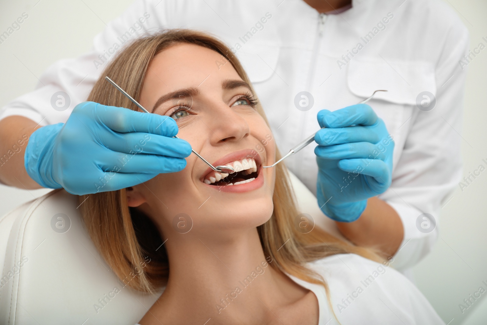 Photo of Doctor examining patient's teeth, closeup. Cosmetic dentistry