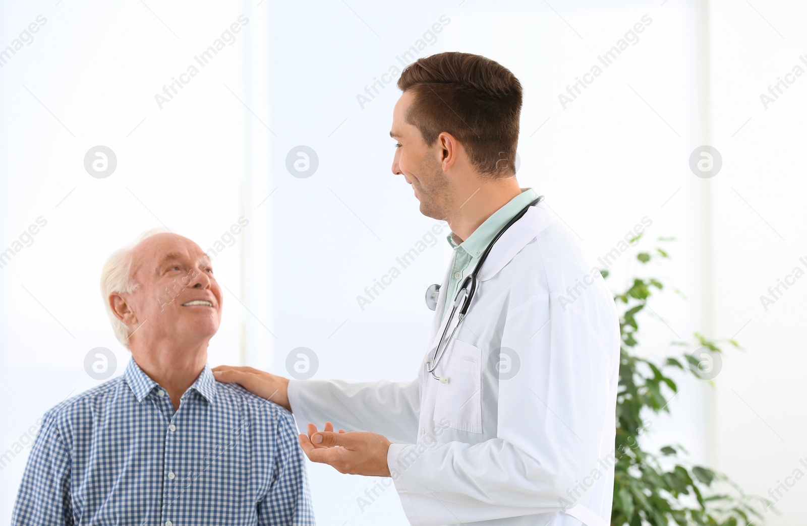 Photo of Doctor working with elderly patient in hospital