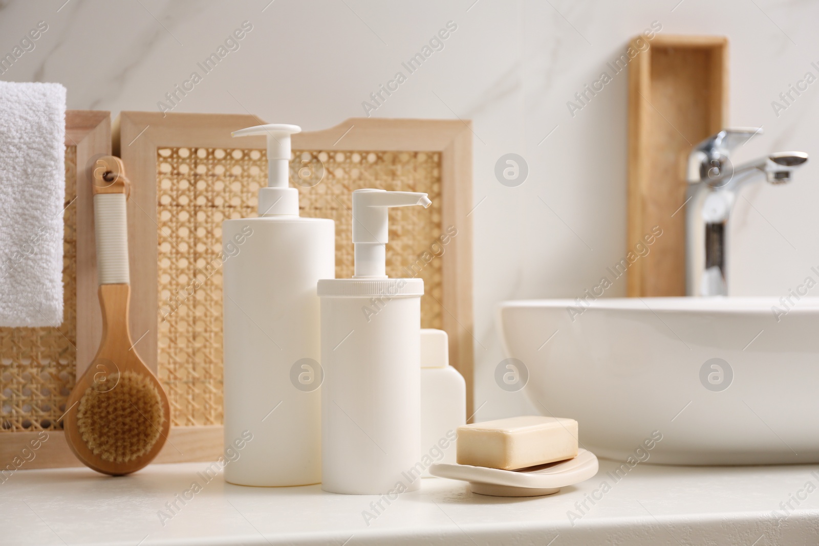 Photo of Toiletries and personal hygiene products on white countertop in bathroom