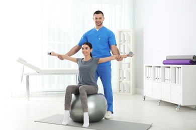 Doctor working with patient in hospital. Rehabilitation exercises