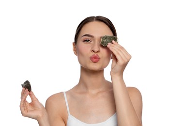 Young woman with green tea bags on white background. Eye skin care