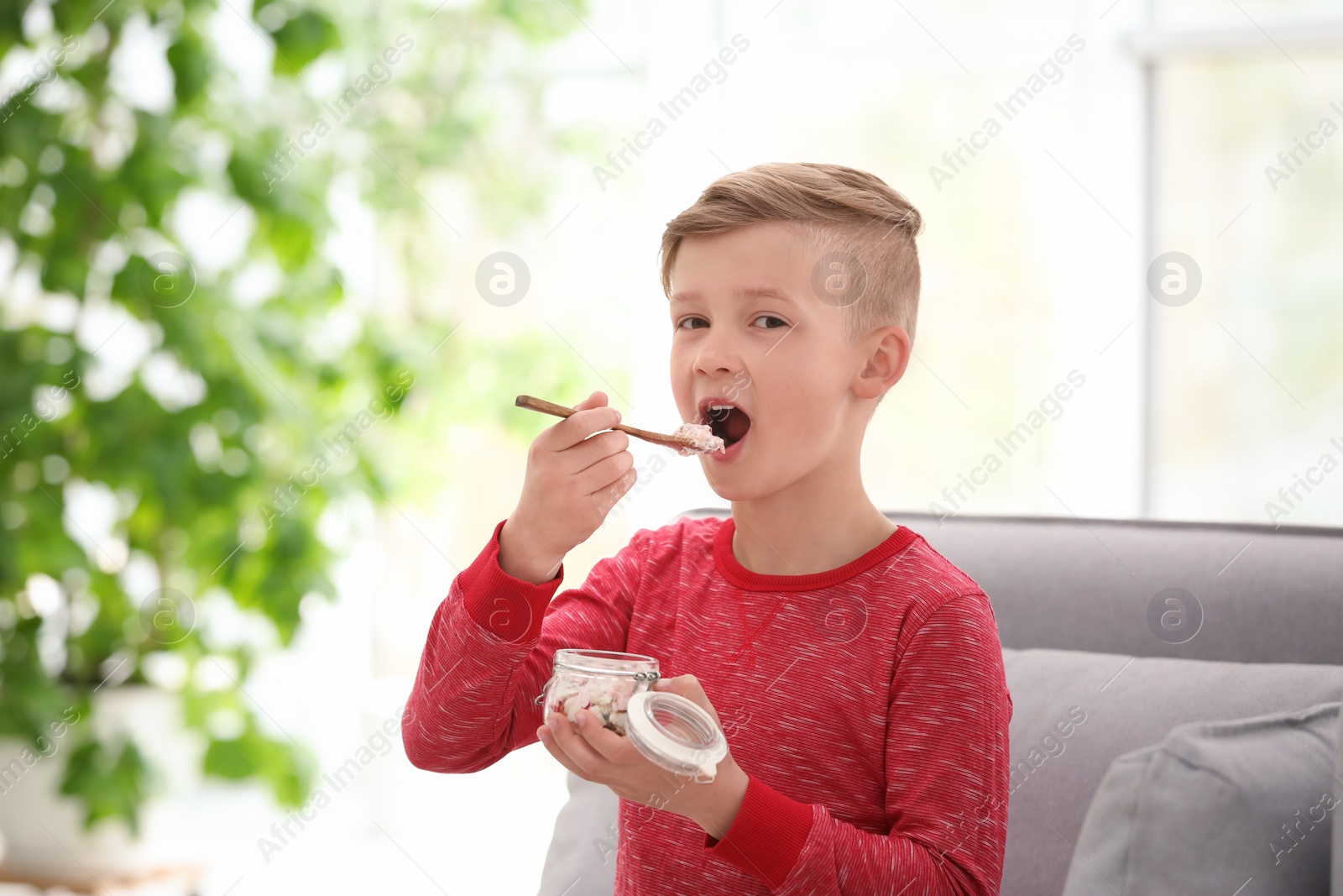 Photo of Little boy with yogurt indoors