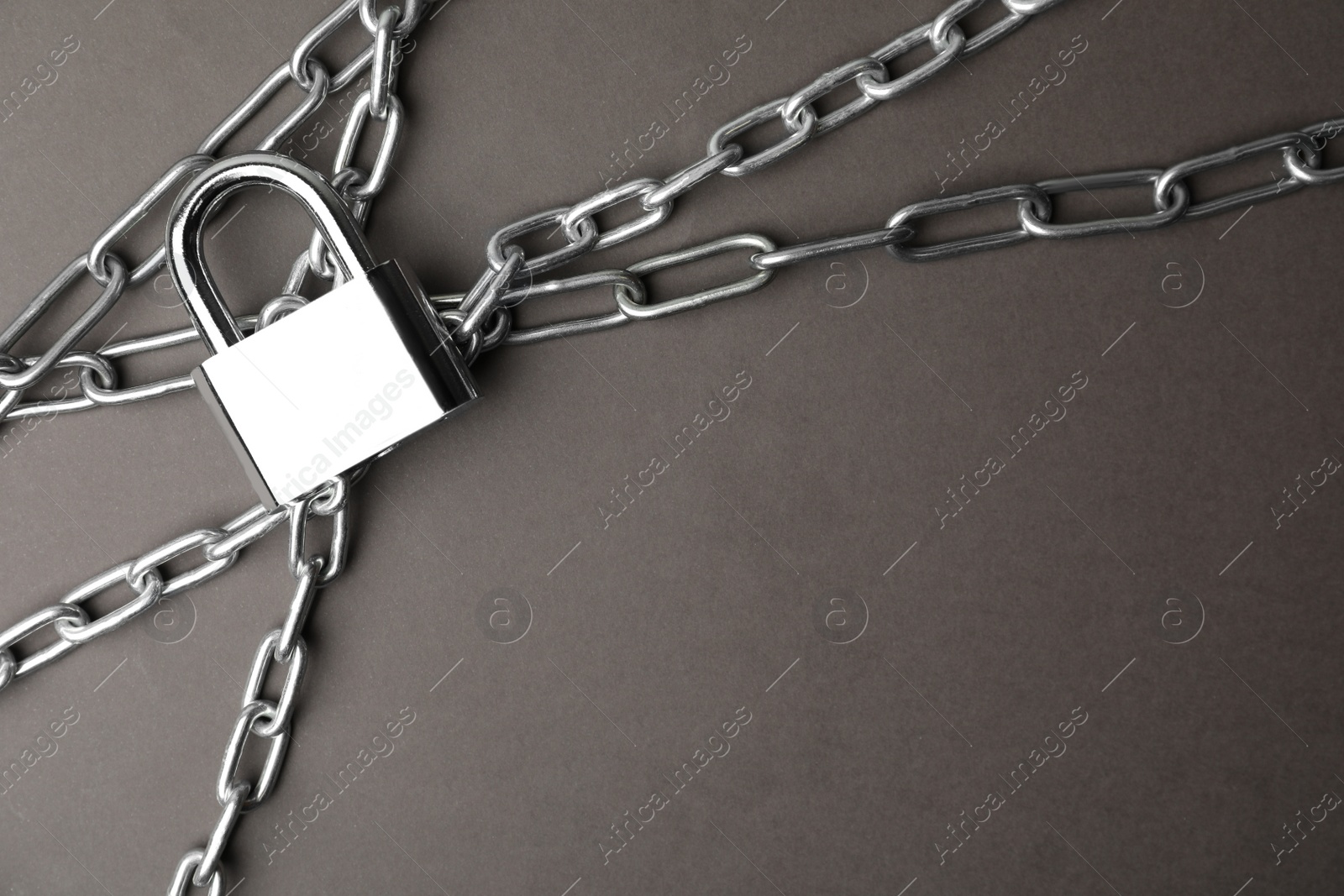 Photo of Steel padlock, chains and space for text on grey background, flat lay. Safety concept