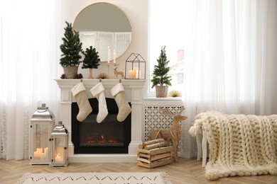 Photo of Fireplace in room with Christmas decorations. Interior design