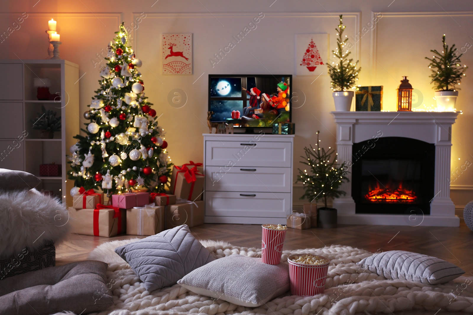 Image of Stylish living room interior with TV set, Christmas tree and fireplace