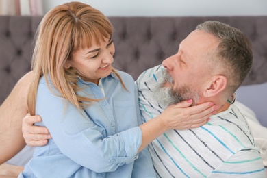 Photo of Mature couple on bed together at home