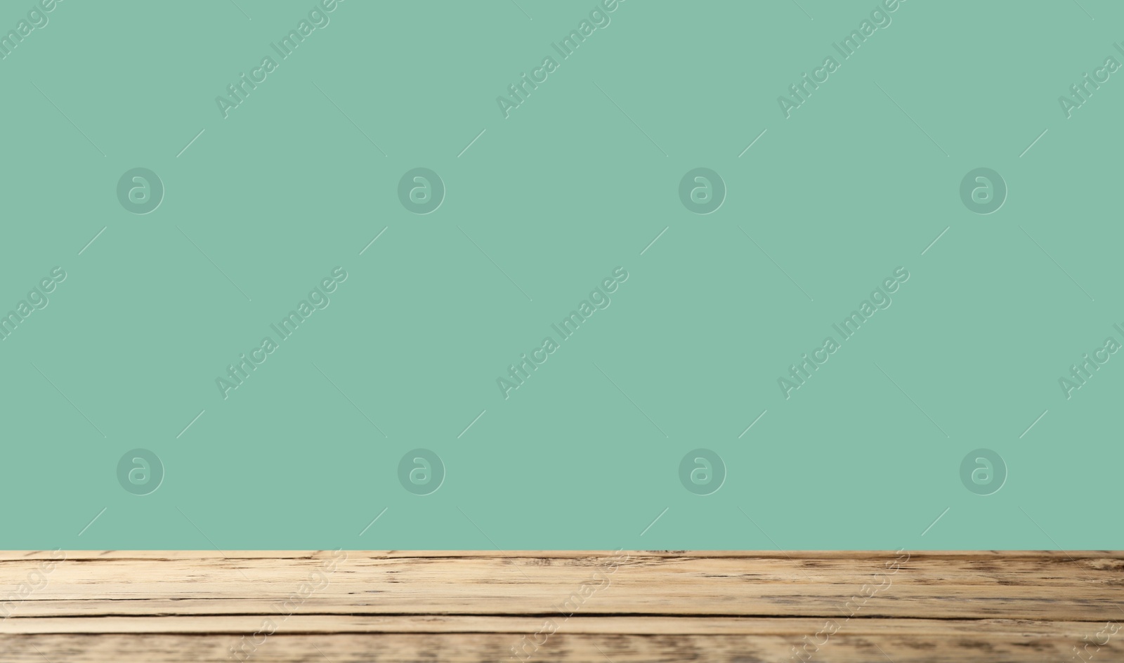 Image of Empty wooden surface on mint background. Mockup for design