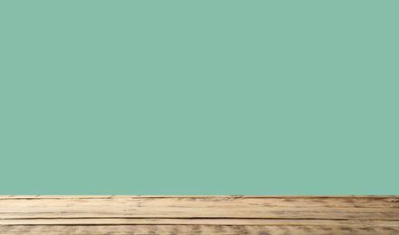 Empty wooden surface on mint background. Mockup for design