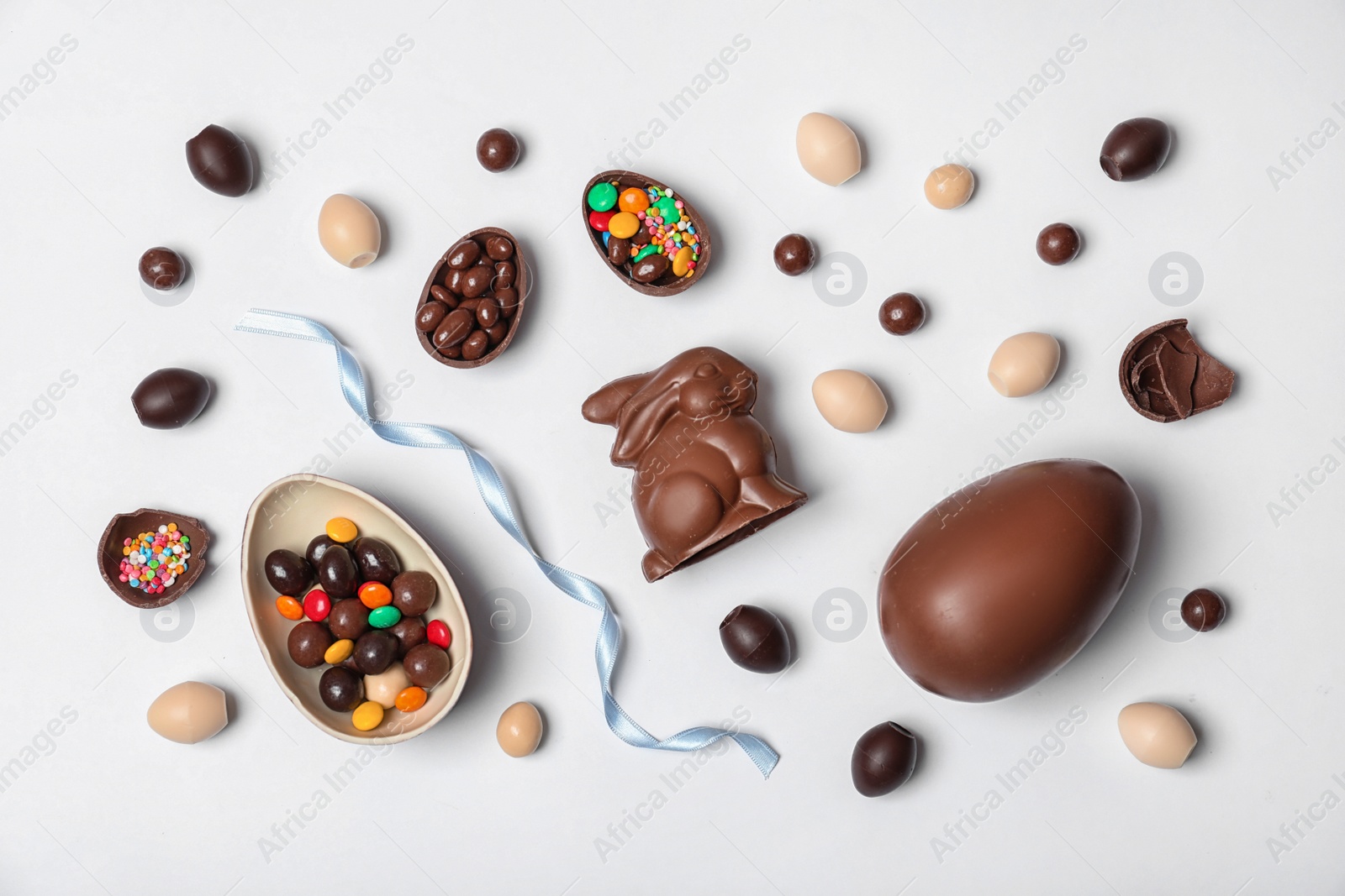 Photo of Flat lay composition with chocolate Easter eggs on white background