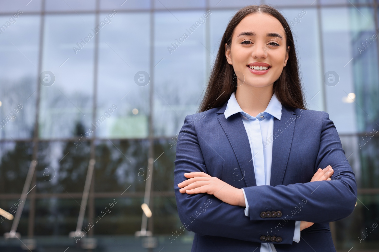 Photo of Happy real estate agent outdoors. Space for text