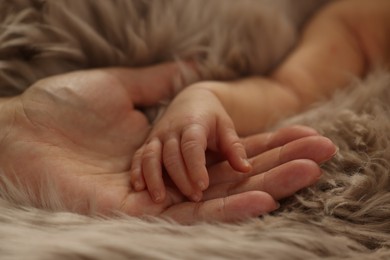 Photo of Mother with her newborn baby on fluffy blanket, closeup. Lovely family