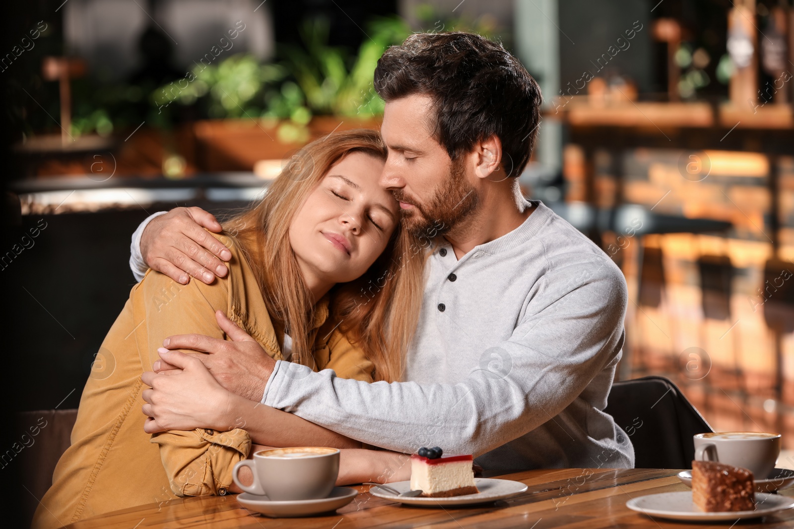 Photo of Romantic date. Lovely couple spending time together in cafe