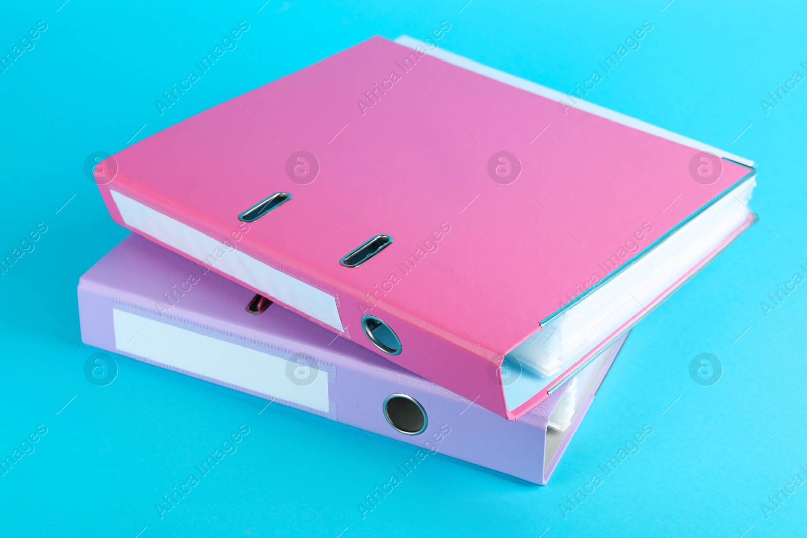 Photo of Hardcover office folders on light blue background