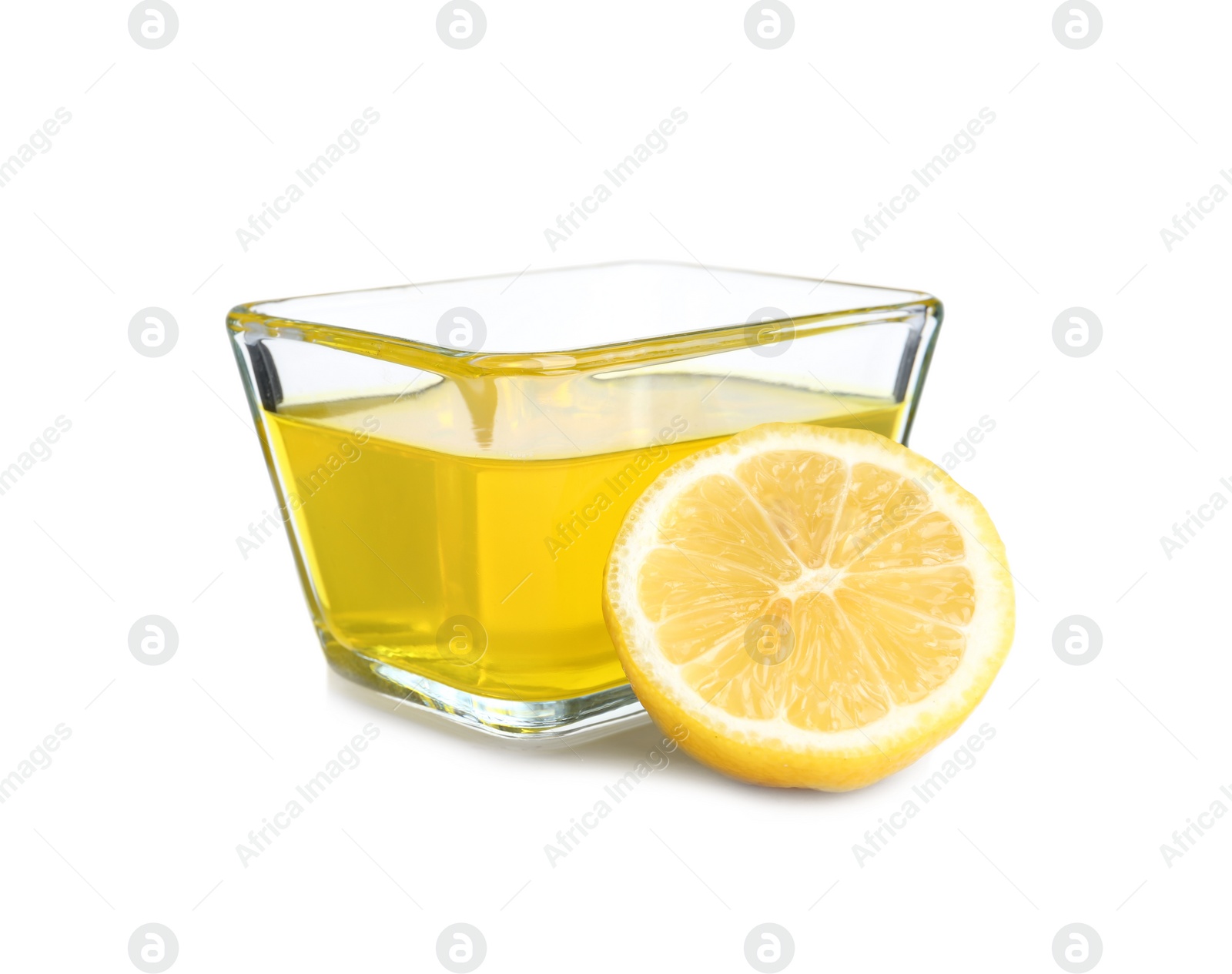 Photo of Piece of lemon and tasty jelly dessert in glass bowl on white background