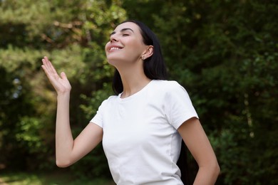 Photo of Feeling freedom. Happy woman enjoying nature outdoors