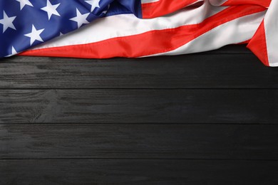 American flag on black wooden table, top view with space for text. Memorial Day