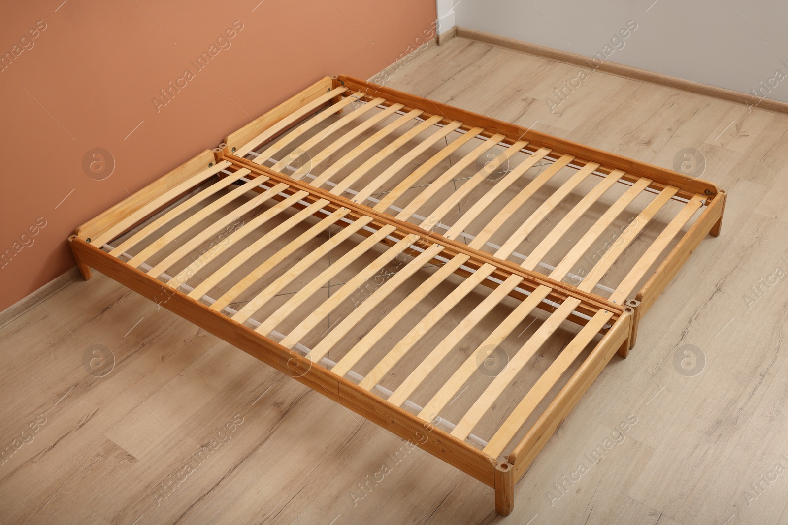 Photo of Wooden bed frame on floor in room