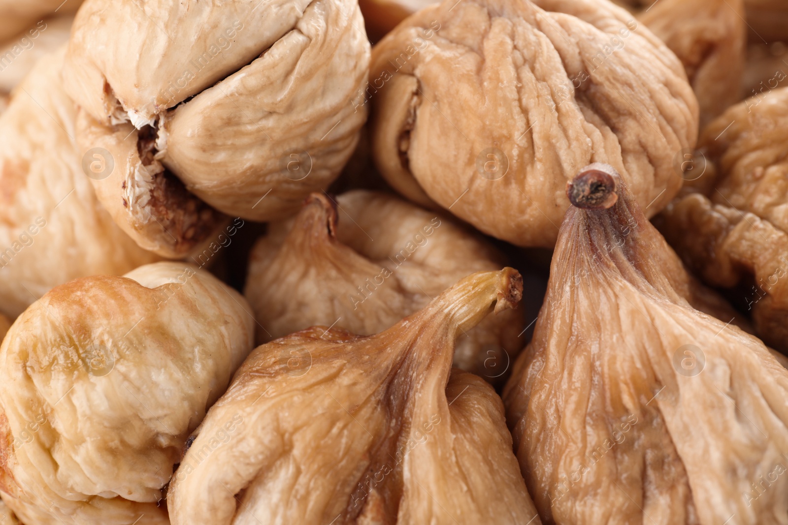 Photo of Tasty figs as background, closeup. Healthy dried fruit